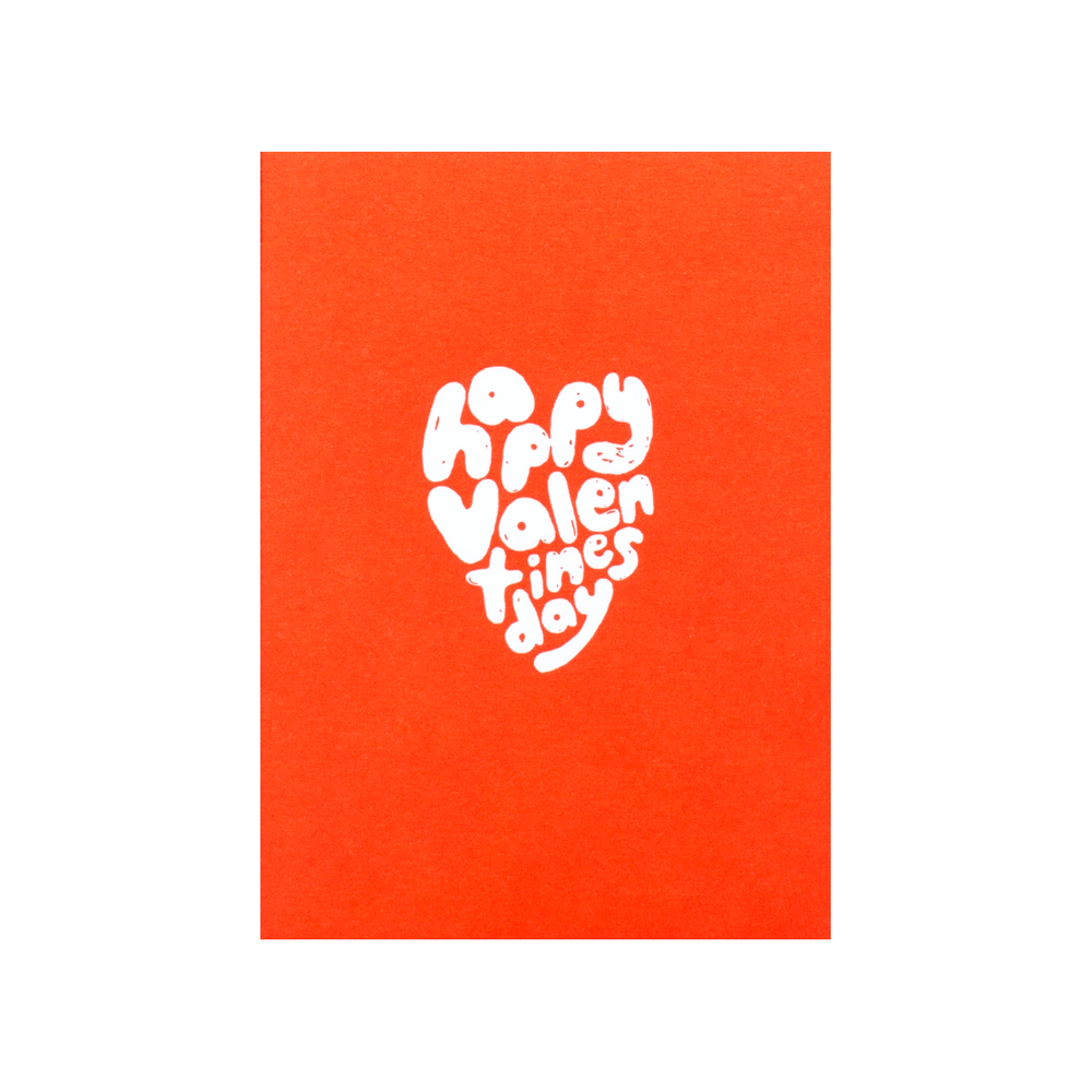 Handwritten happy valentines day in the shape of a heart on a red background
