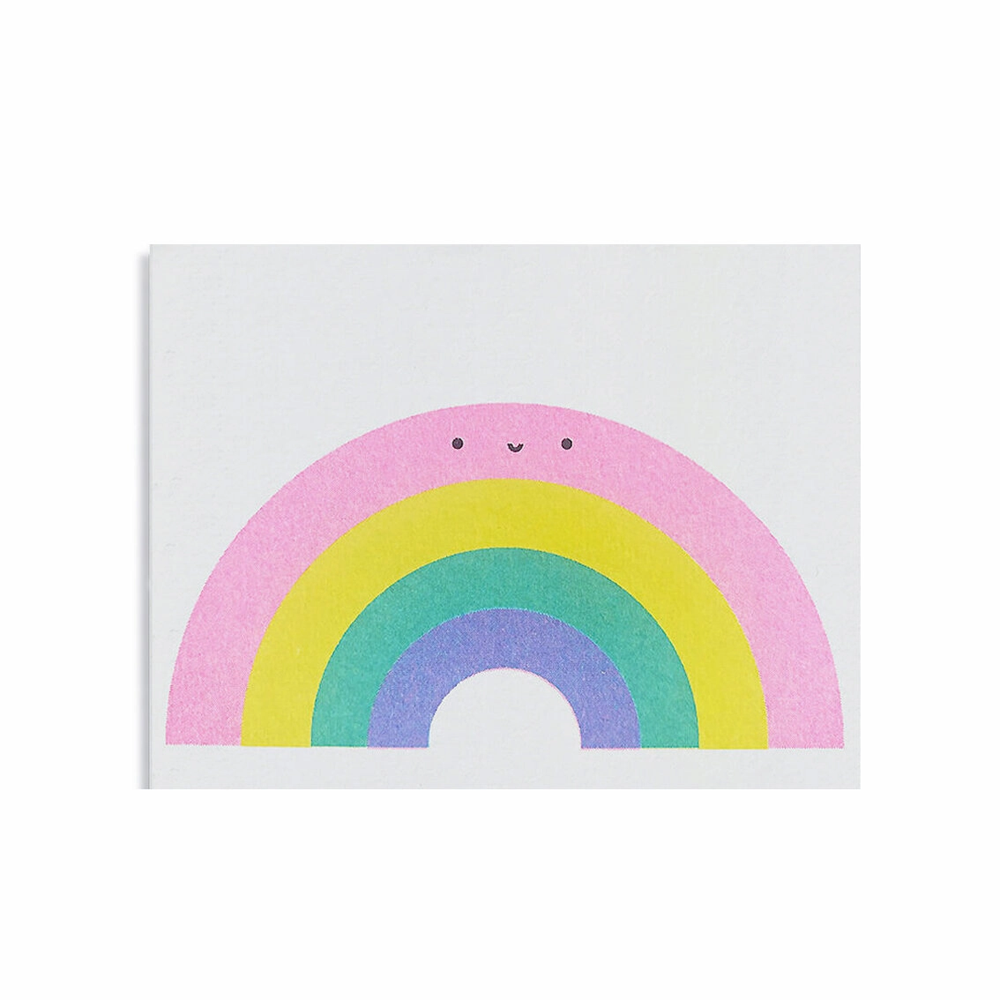 simple rainbow image made from 4 different colors the largest on top: pink, yellow, green, blue and a smile made from two black circles for eyes and an upturned line for a smile