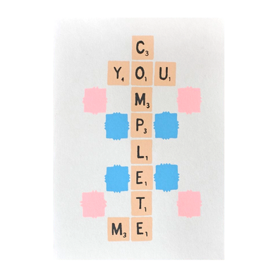 Scrabble tiles that spell out YOU COMPLETE ME