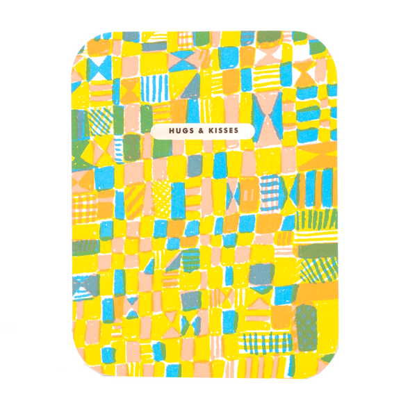 colorful abstract quilt pattern with an oval die-cut window that reveals text inside the card