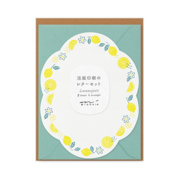 Die-cut curved sheet with a two-color border of lemons and blossoms with a teal envelope.