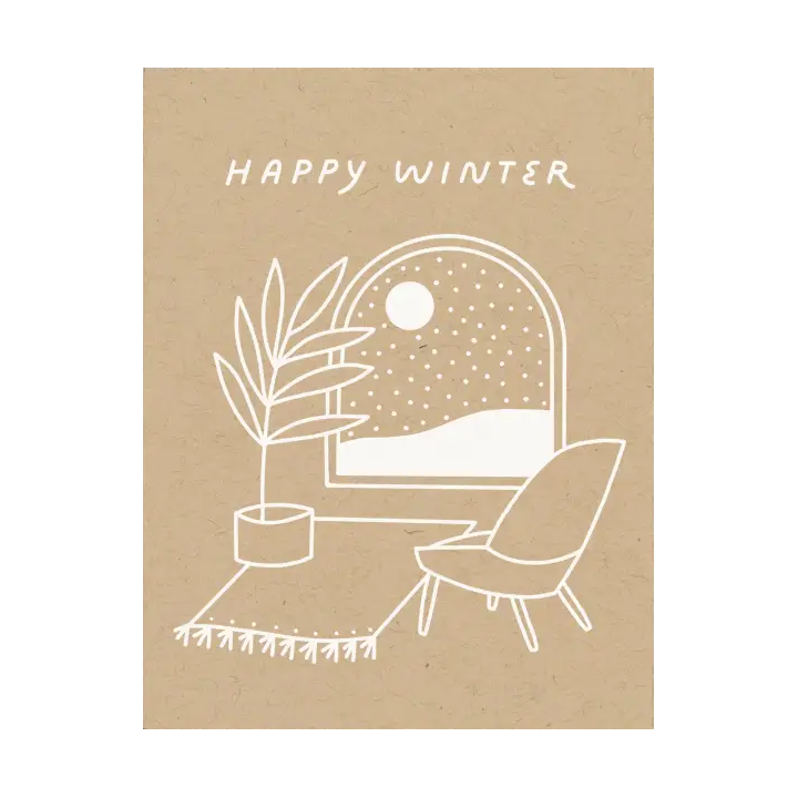 white print on kraft card stock of a winter scene out of a cozy living room window and the text HAPPY WINTER