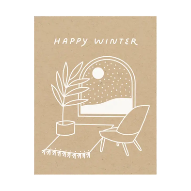white print on kraft card stock of a winter scene out of a cozy living room window and the text HAPPY WINTER